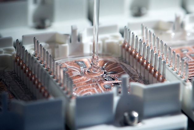 Danfoss Silicon Power manufacturing process of a power module showing addition of silicon paste.