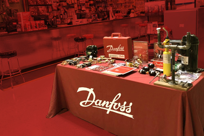 distributor table with Danfoss products and red backdrop
