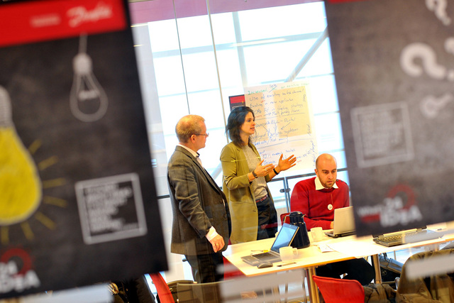 People working, talking behind signs