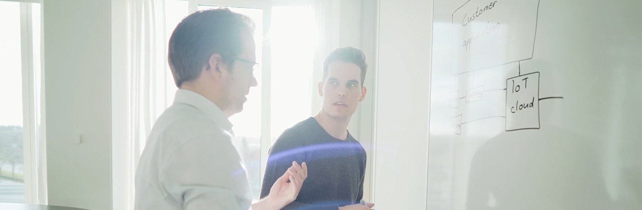 Nicklas, student worker and colleague at whiteboard