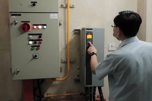 Man programming a HVAC FC 102 drive