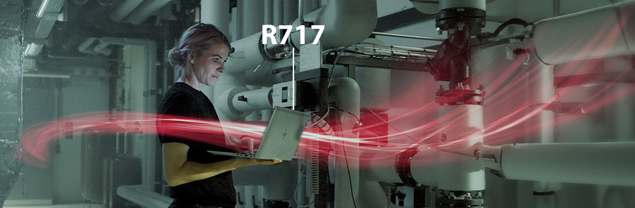 woman holding a laptop with red network visualization 