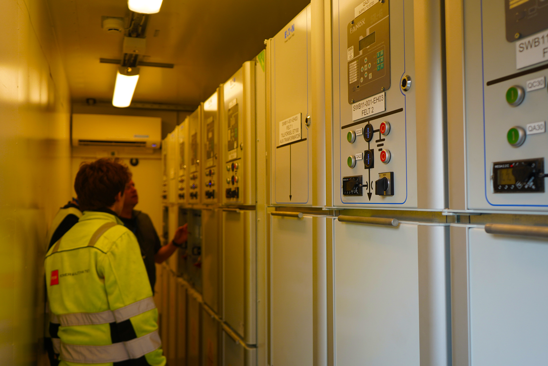 Kristoffer Hjelle, Lead Automation Engineer at PSW, and Torv Halle, PSW Technician, inside one of the switchboard containers.