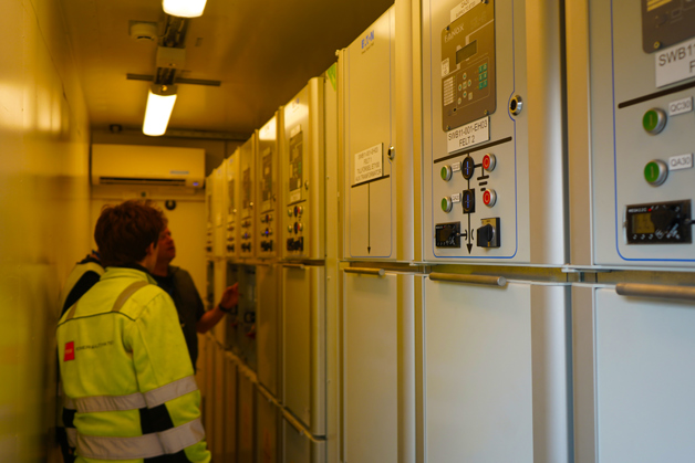 Kristoffer Hjelle, Lead Automation Engineer at PSW, and Torv Halle, PSW Technician, inside one of the switchboard containers.
