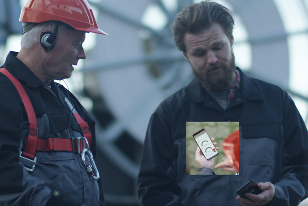 Two men monitoring the drives through a phone app