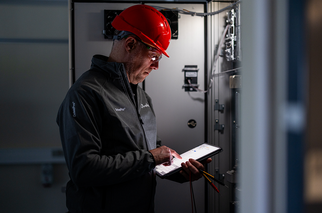 Service man looking at a tablet with documentation
