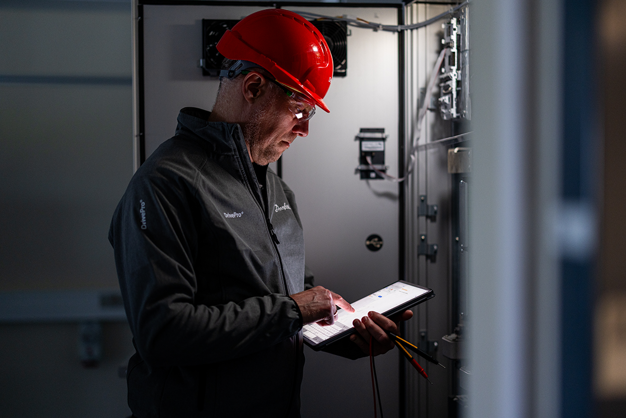 Service man looking at a tablet with documentation