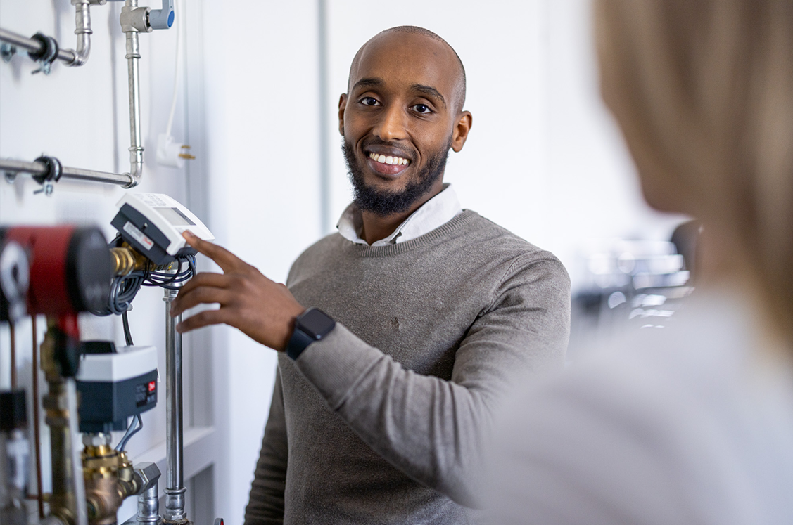 Service man looking at the Danfoss documentation
