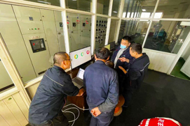 Engineers from Dahe Paper Group talking and looking at their custom dashboard built by Danfoss