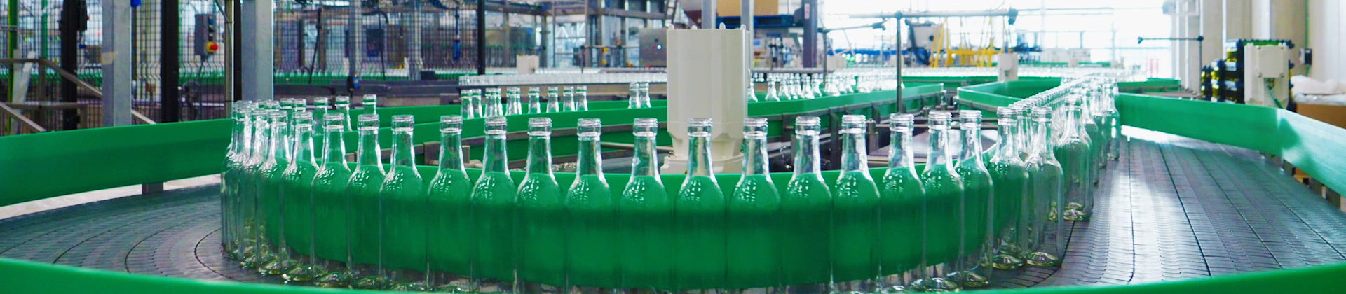 Green bottles on a bottling line at Delhaize winery