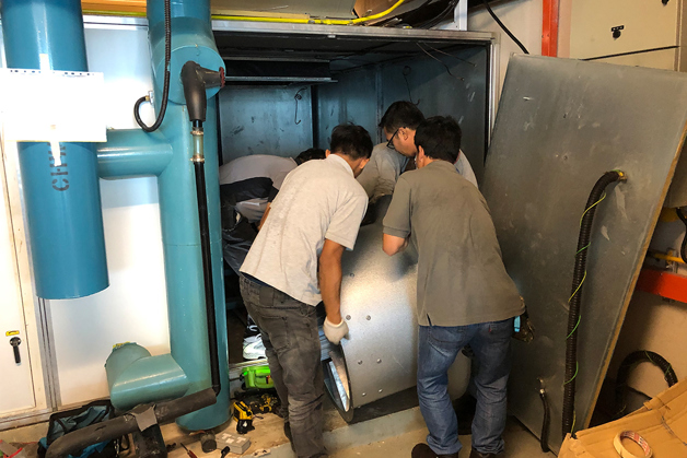3 men installing a ZerAx fan, and the text "Less than 10 hours for retrofit work"