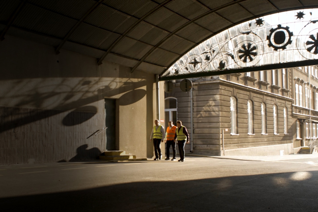 3 men walking at Carlsberg's Okocim Brewery